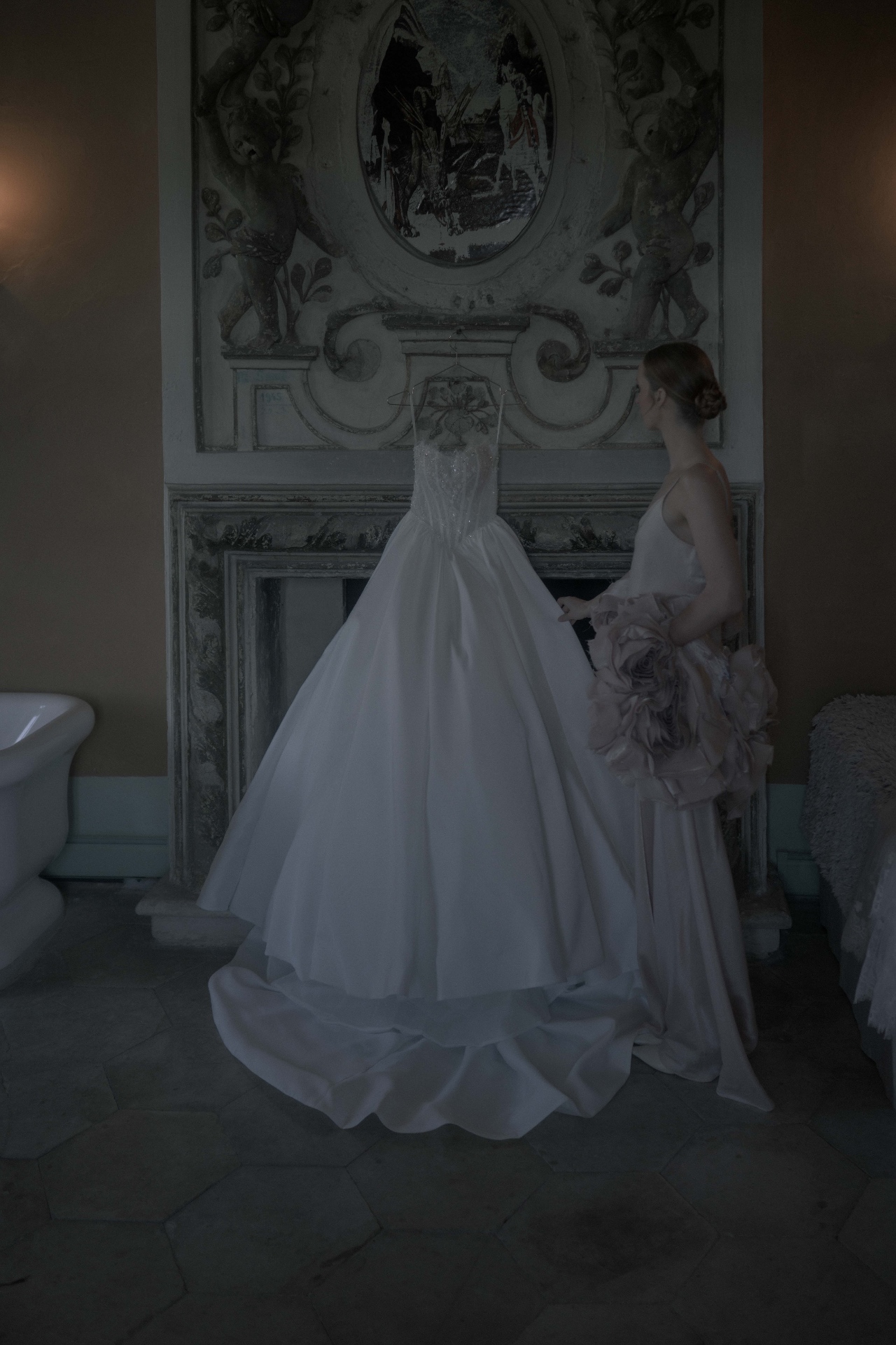 Wedding dress hanging beside historic architecture