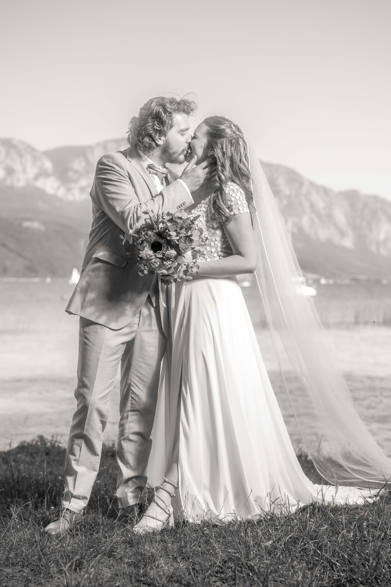 Bride and groom embracing at the lakeside