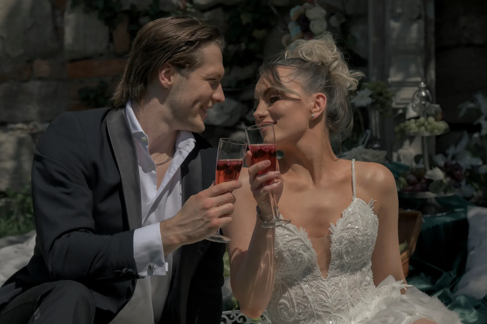 Bride and groom in an intimate editorial wedding portrait beside historic masonry at Schloss Haggenberg.