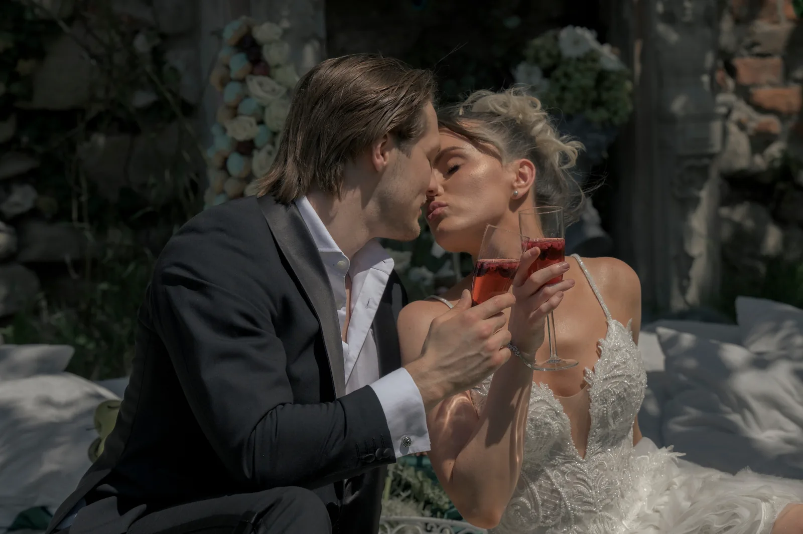 Quiet close wedding portrait of the couple beneath a crystal chandelier at Schloss Haggenberg.