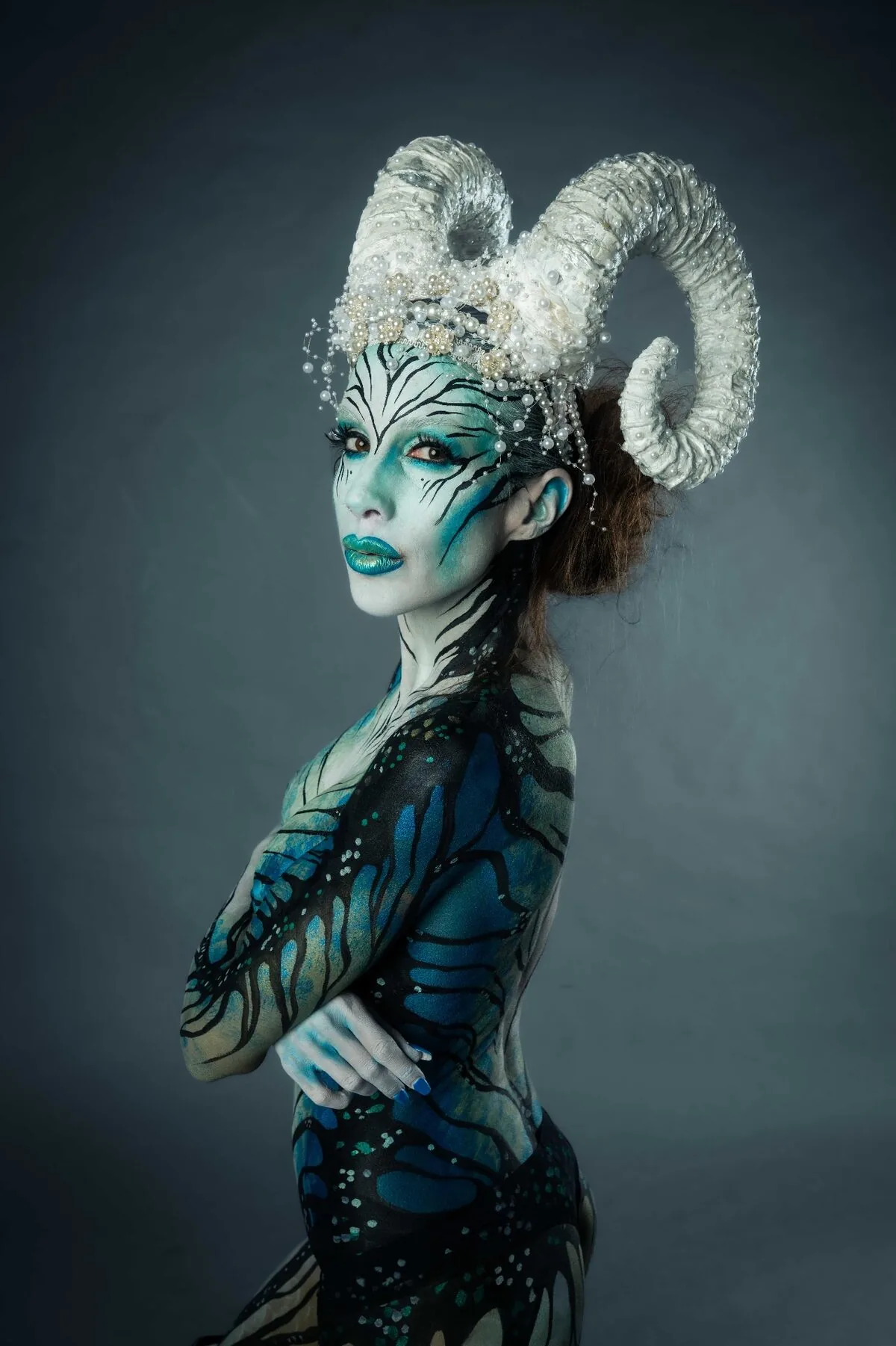 Professional fine-art bodypainting portrait photography Vienna - blue metallic alien beauty with custom headpiece shot by Peter Scholz