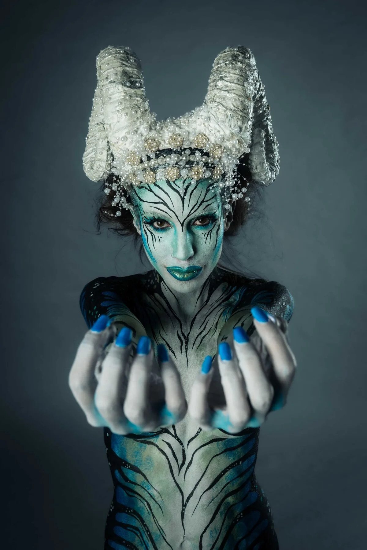 Creative bodypainting photography editorial - metallic blue skin texture with futuristic headpiece design Nikon Z9