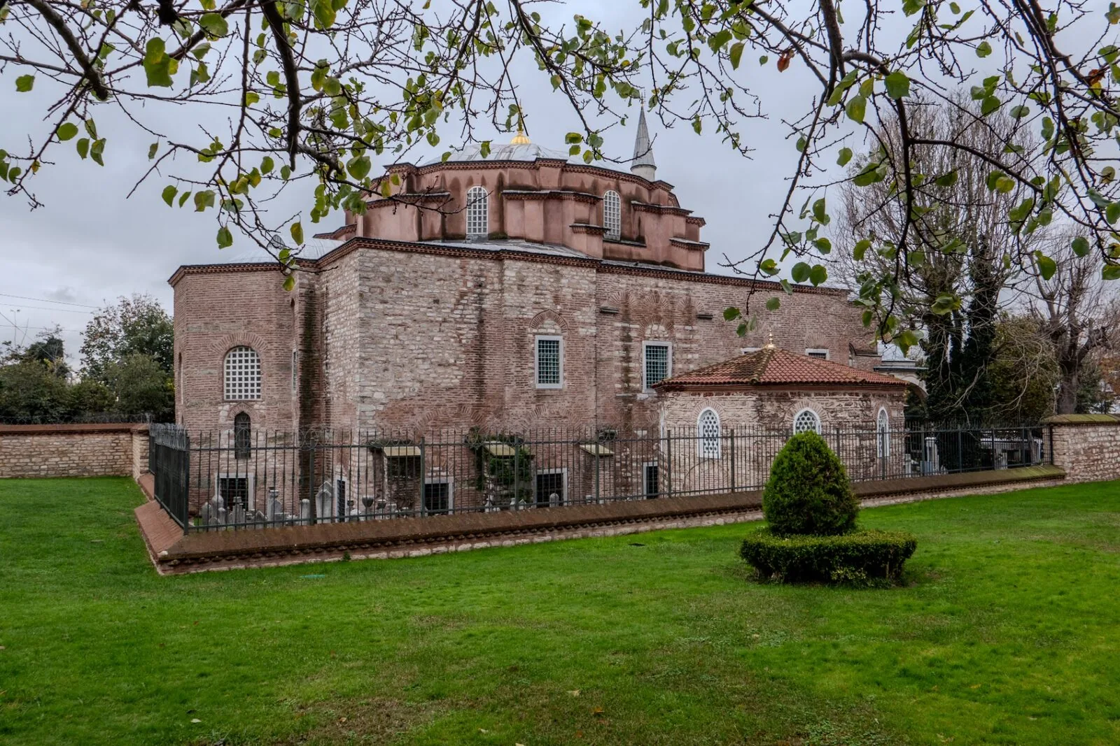 Little Hagia Sophia exterior view showing Byzantine brick dome and garden setting in Istanbul