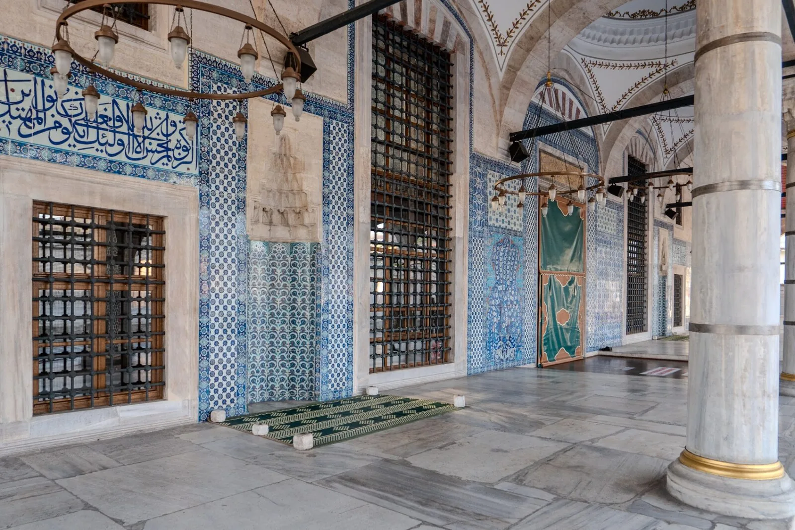 Rüstem Pasha portico entrance with marble columns and prayer rugs