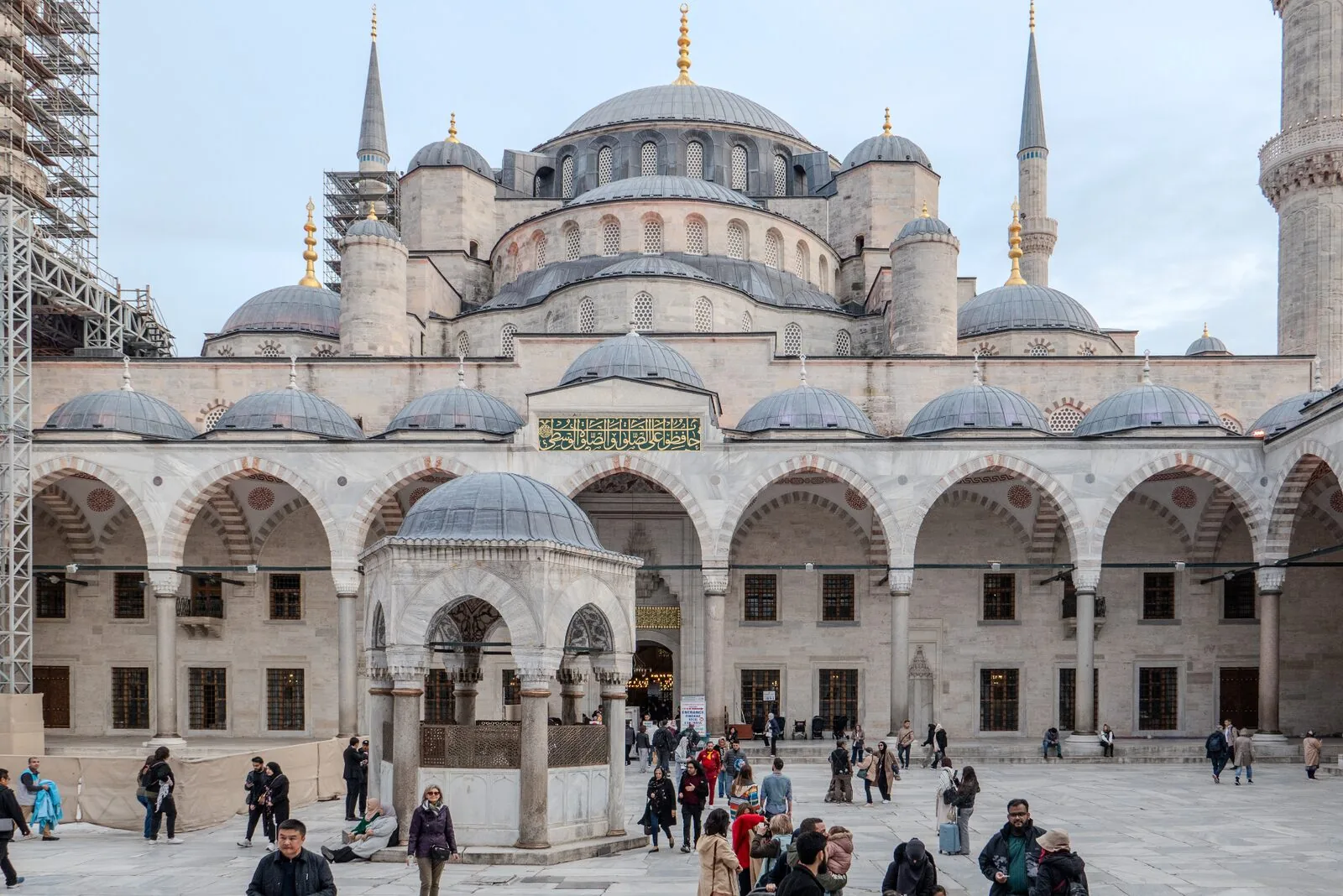 Sultan Ahmed Blue Mosque Istanbul courtyard with cascading domes and six minarets against blue sky