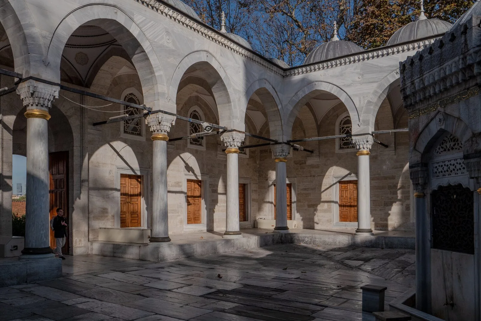 Yeni Valide Mosque Üsküdar courtyard with pointed arches marble columns and dramatic shadows