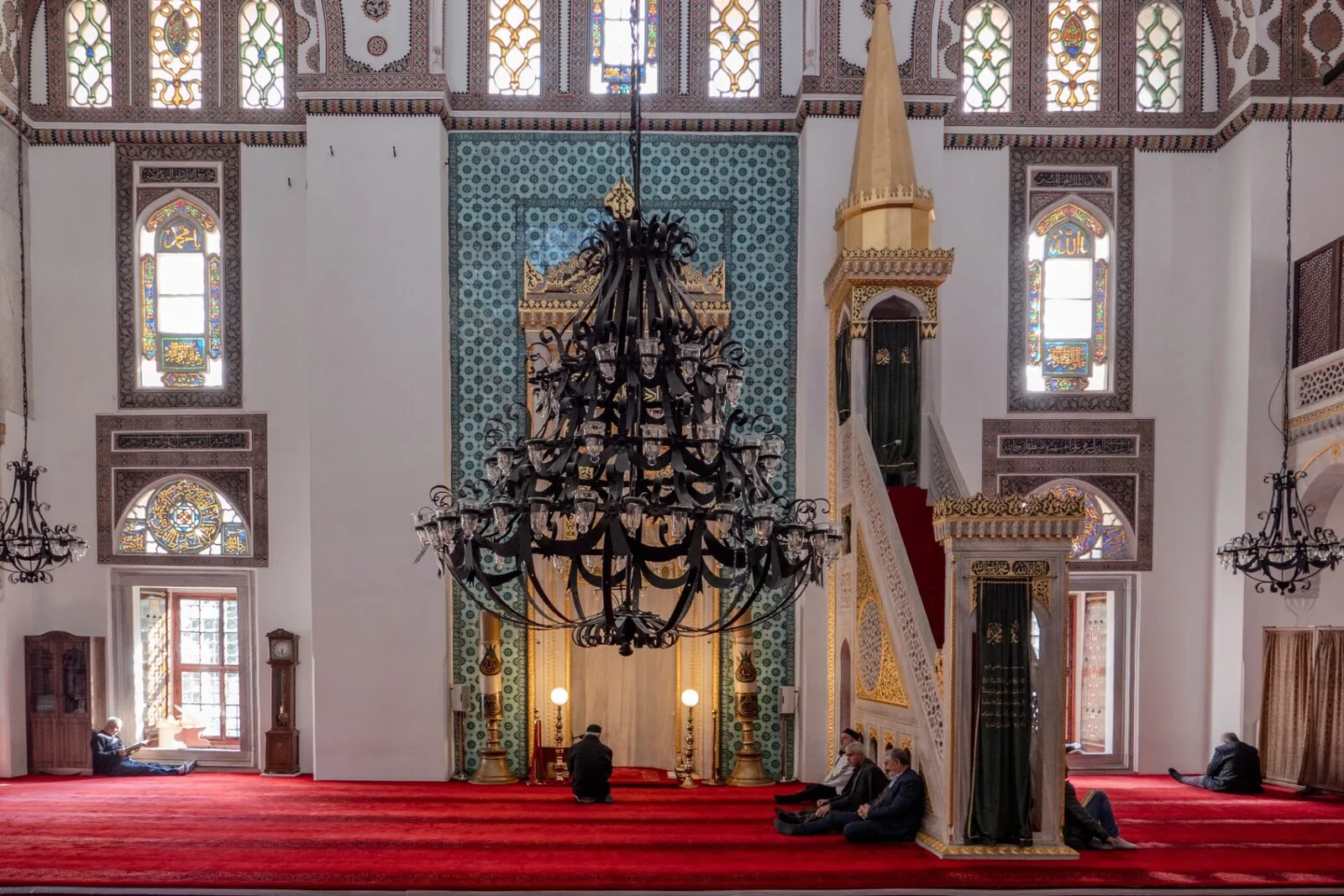 Yeni Valide interior prayer hall with iron chandelier mihrab minbar and teal tile work