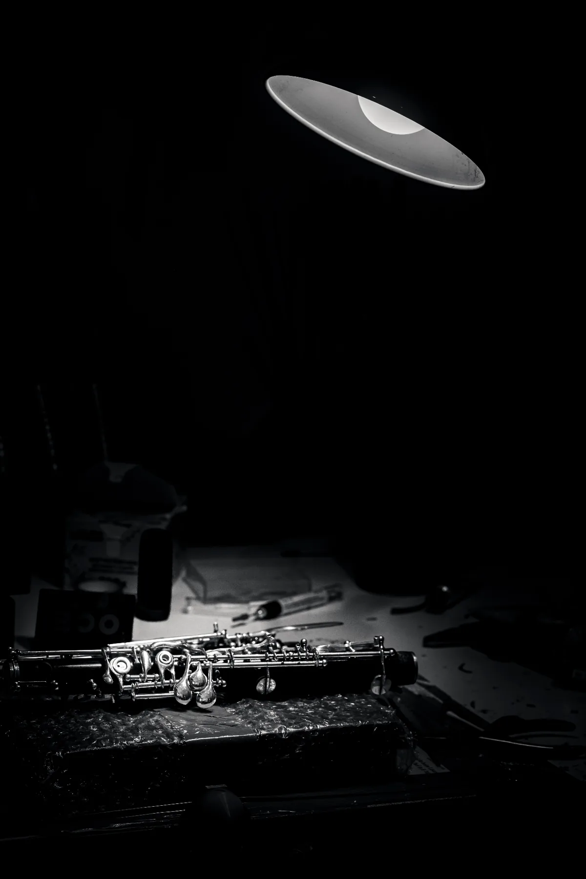 A handcrafted clarinet illuminated on a workbench inside the workshop of Viennese master woodwind instrument maker Florian Köck.