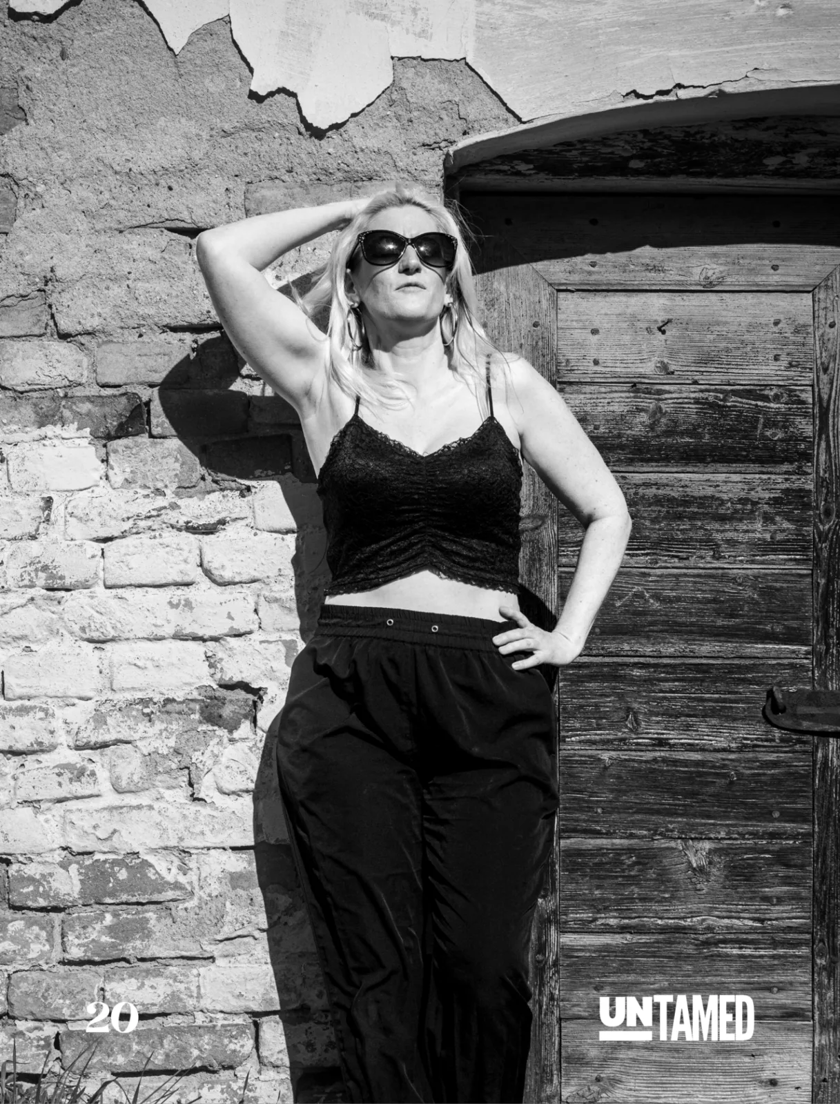 Untamed Fashion Vol. 277 page 20 — black and white fashion portrait with strong sunlight and textured wall