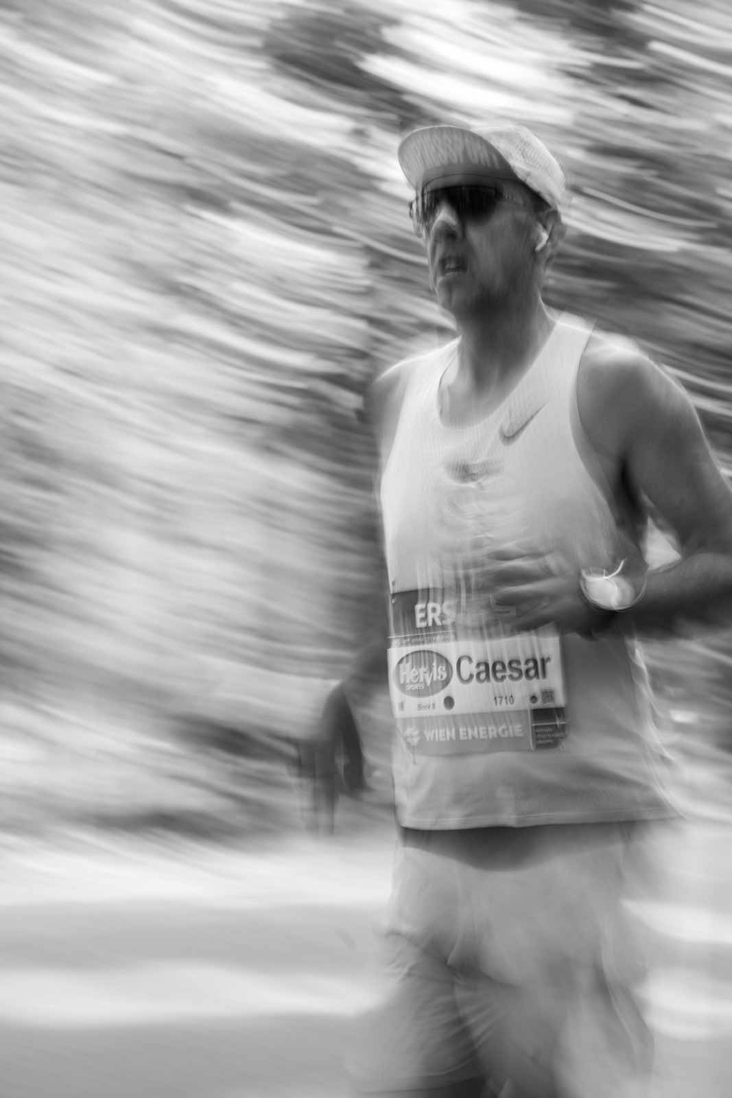 Marathon runner Caesar in motion blur at the Vienna City Marathon — black and white fine art photography by Peter Scholz, schopho