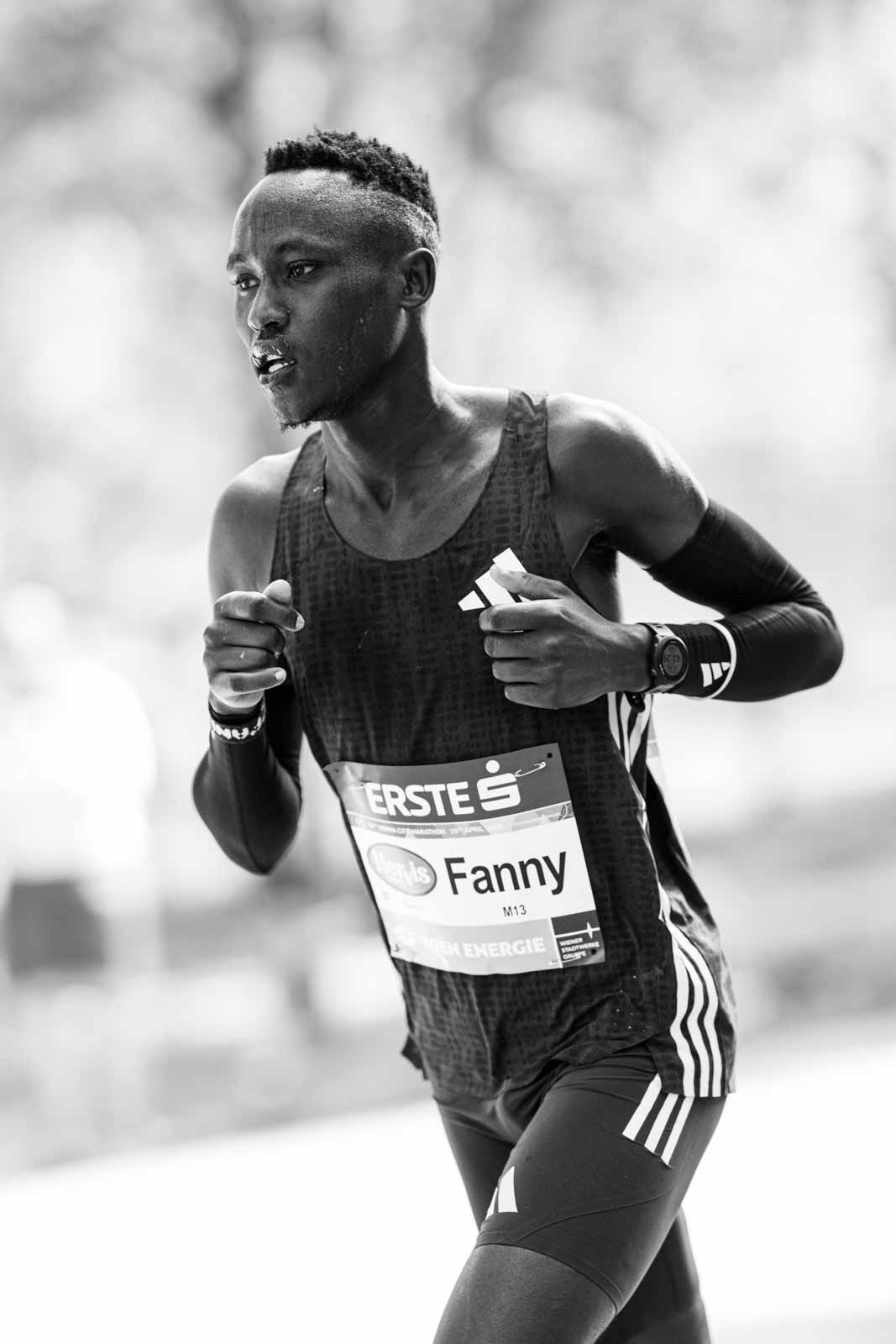 Marathon runner Fanny mid-stride at the Vienna City Marathon — black and white editorial photography by Peter Scholz