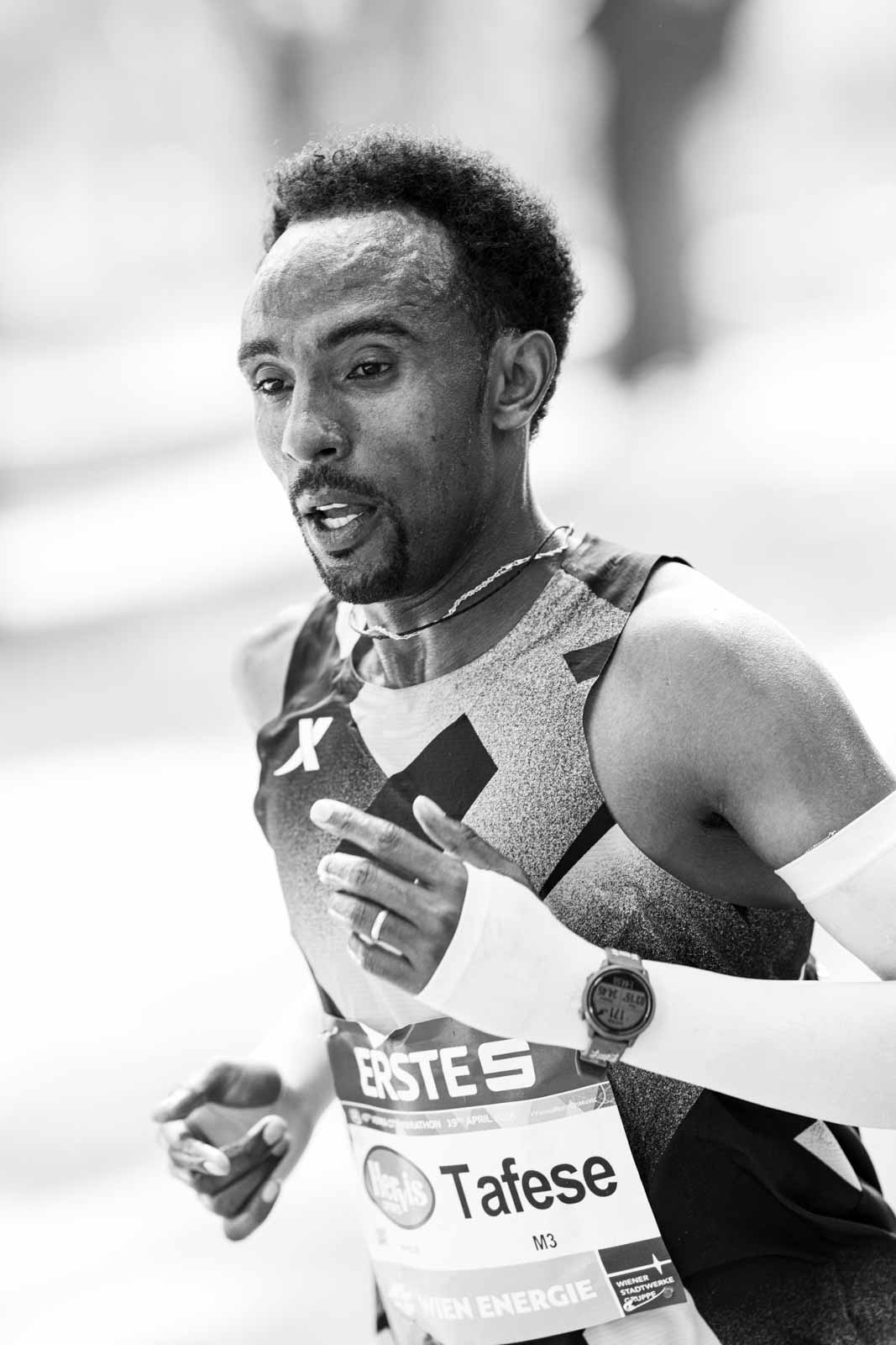 Close-up of marathon runner Tafese in concentration at the Vienna City Marathon — black and white fine art photography by schopho