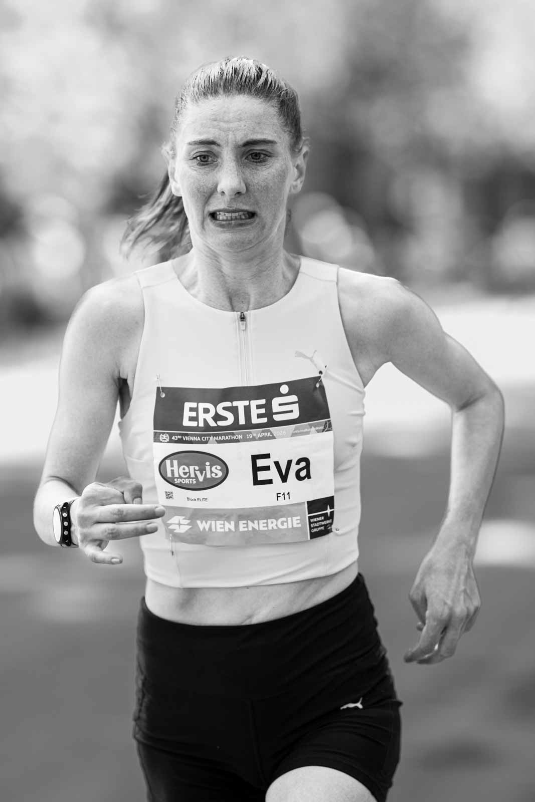 Female marathon runner Eva mid-race at the Vienna City Marathon — black and white fine art portrait photography by schopho