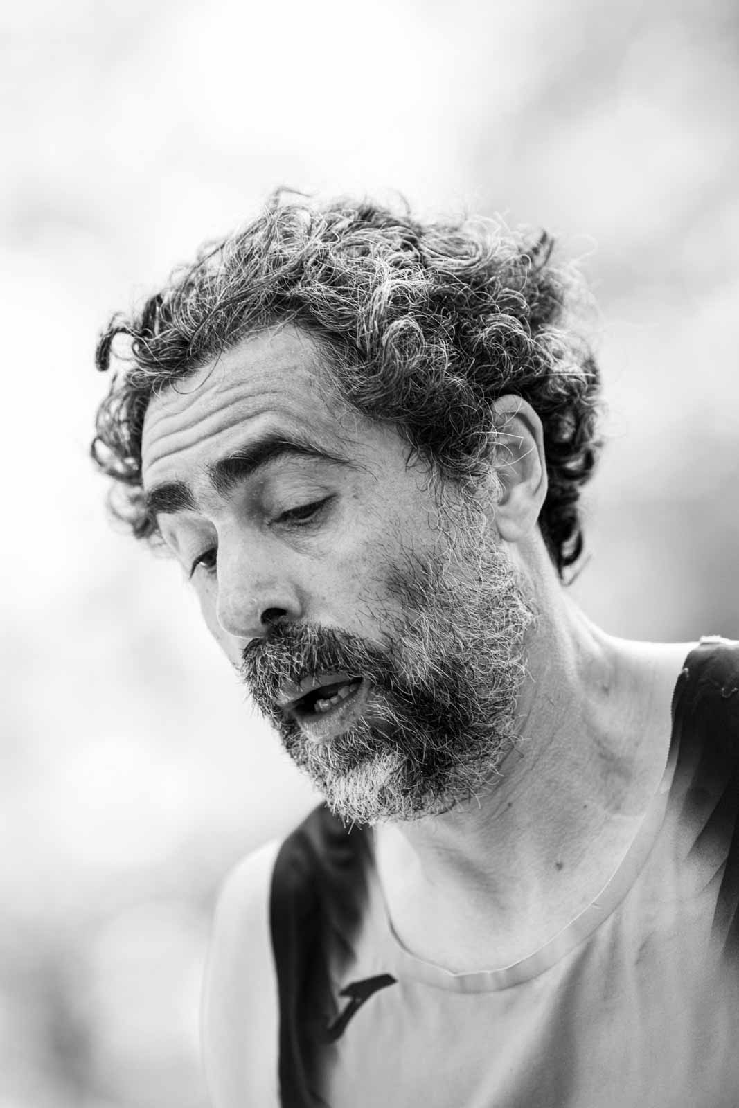 Intimate portrait of a bearded marathon runner after the finish — black and white fine art photography by Peter Scholz
