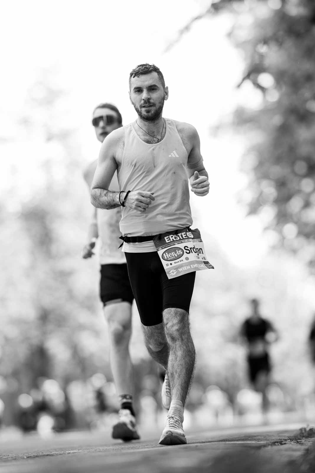Marathon runner Srdjan running head-on through the Prater Hauptallee — black and white fine art photography by schopho