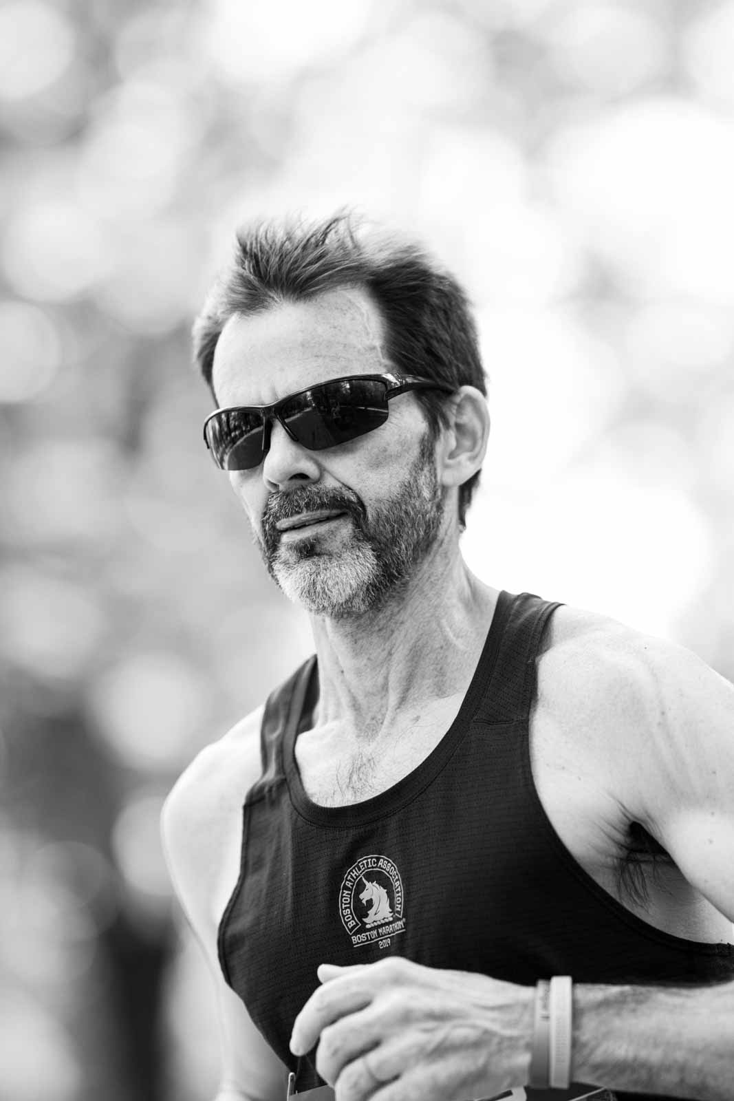 Portrait of an experienced marathon runner with Boston Marathon singlet — black and white fine art photography by schopho