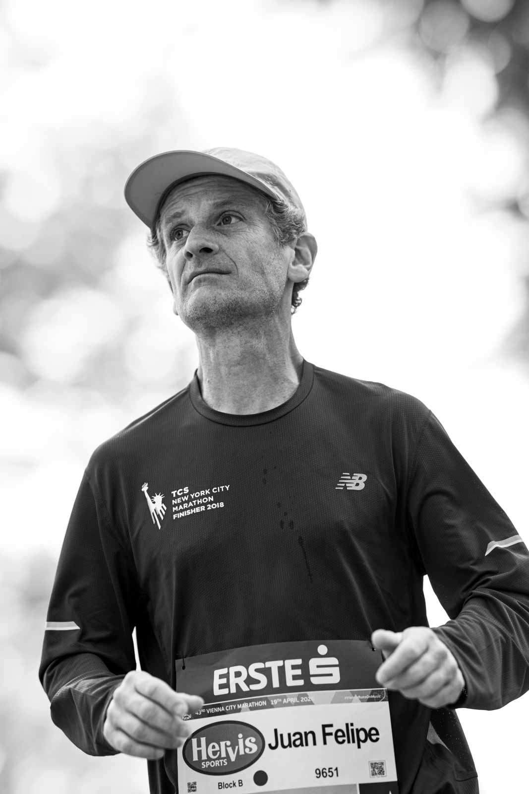 Marathon runner Juan Felipe with TCS New York City Marathon Finisher 2018 shirt — black and white portrait photography by Peter Scholz