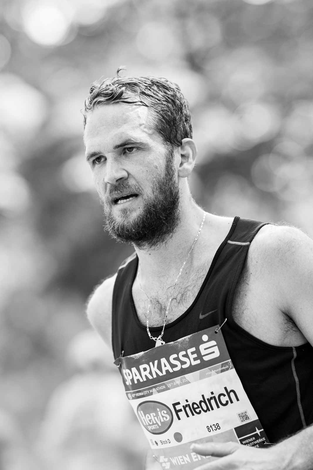 Marathon runner Friedrich with full beard and silver chain at the Vienna City Marathon — black and white fine art photography by schopho