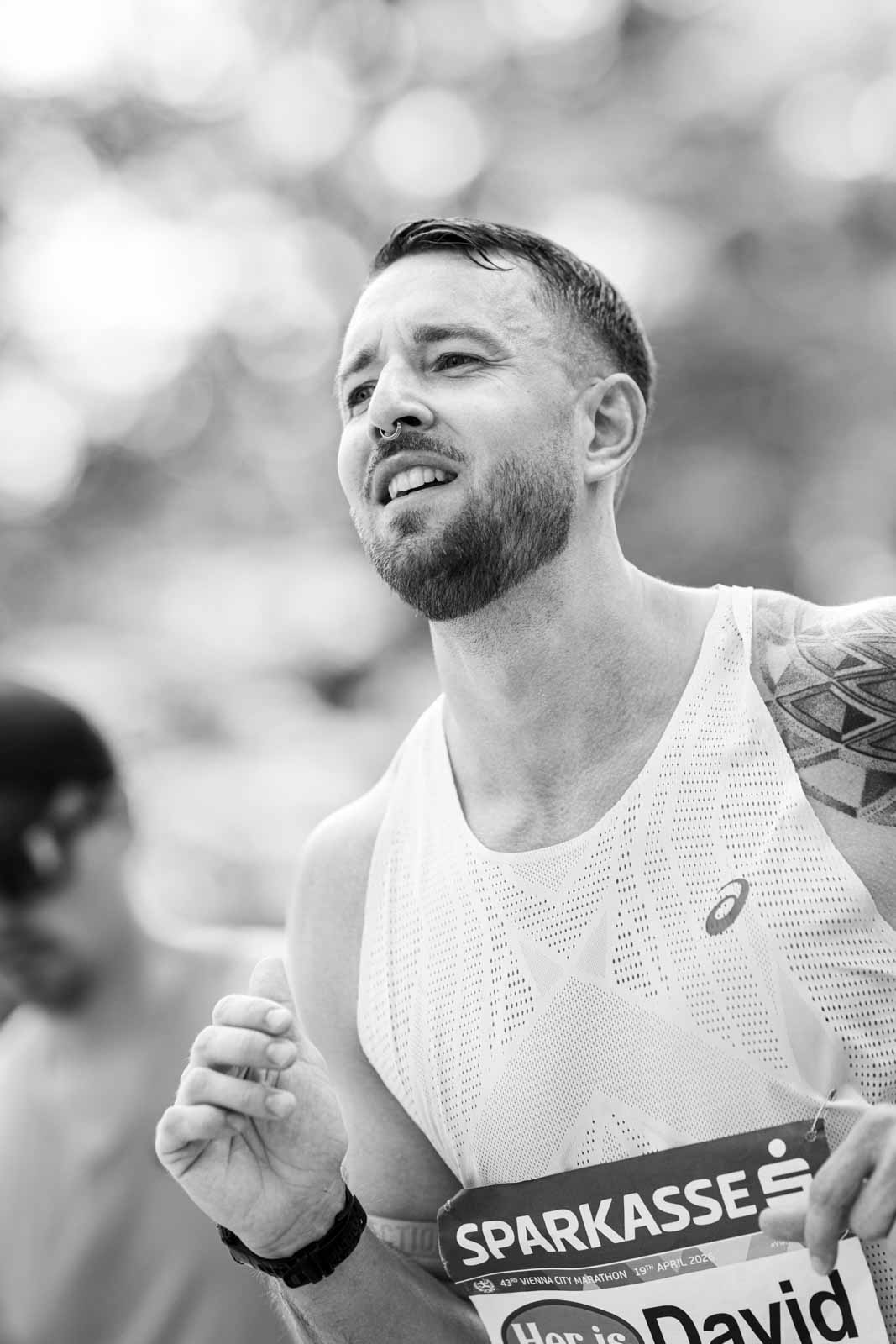 Marathon runner David with septum piercing and Asics singlet — black and white fine art portrait photography by Peter Scholz