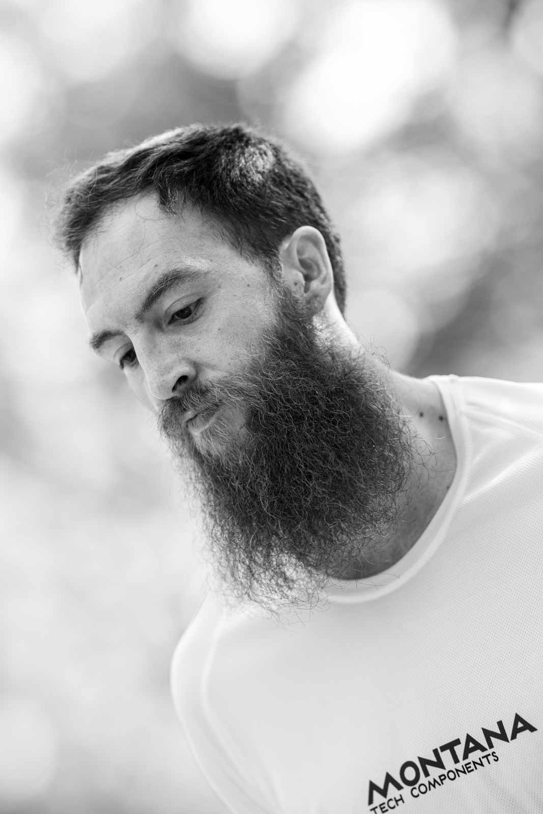 Intimate portrait of a bearded marathon runner with Montana Tech Components singlet — black and white fine art photography by Peter Scholz